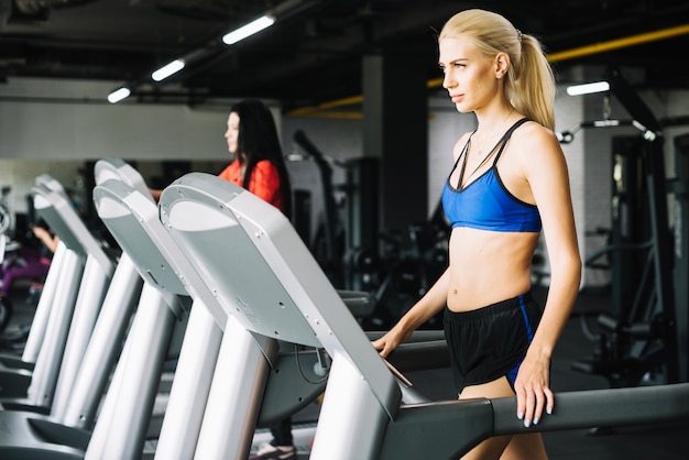 Pretty woman walking on treadmill