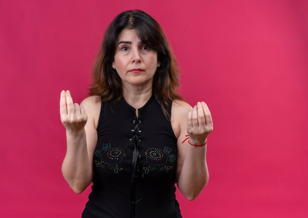 Pretty woman wearing black blouse looking  at a loss showing money sign