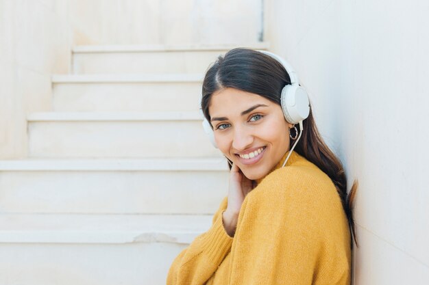 pretty woman wearing headphones looking at camera