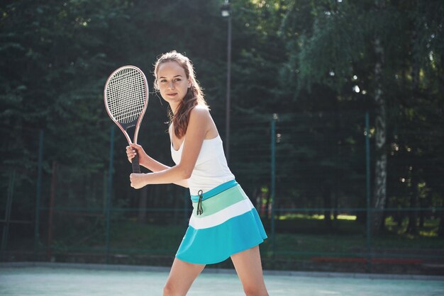 A pretty woman wearing a sportswear tennis court on the court.