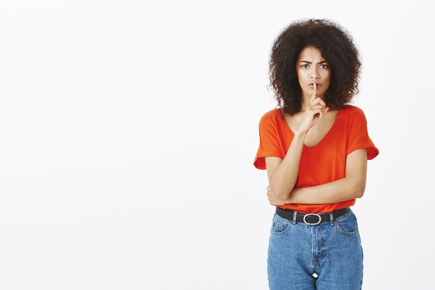 Pretty woman with afro hairstyle posing in the studio