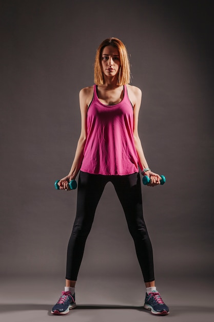 Free photo pretty woman with dumbbells