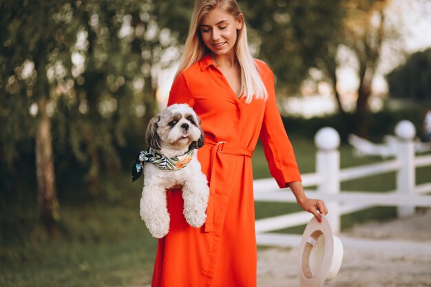 Pretty woman with her cute dog on vacation