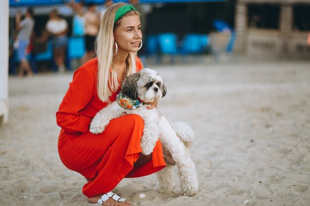 Pretty woman with her cute dog on vacation