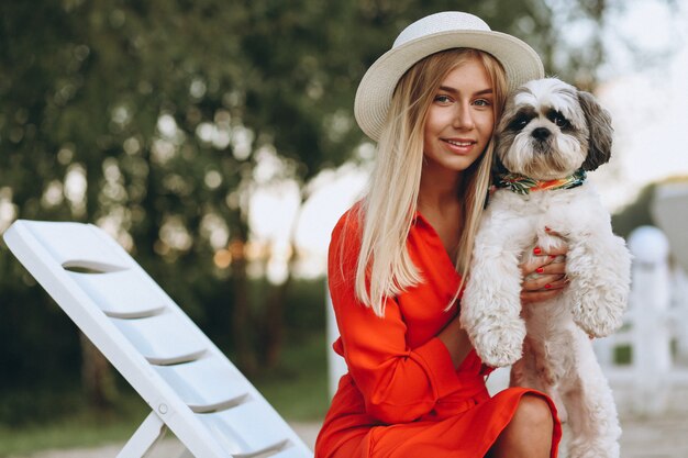 Pretty woman with her cute dog on vacation