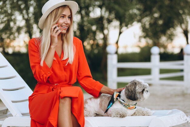 Pretty woman with her cute dog on vacation