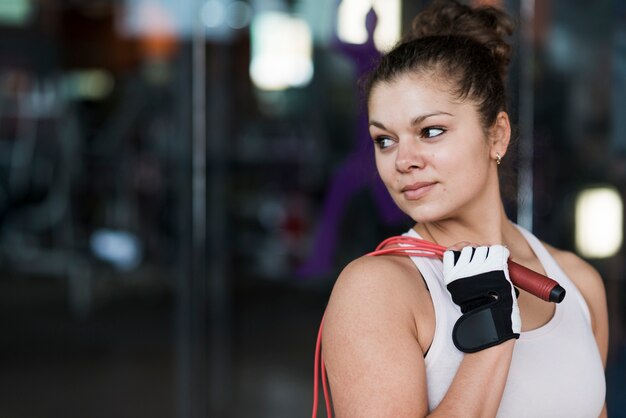 Free photo pretty woman with jumping rope