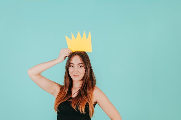 Free photo pretty woman with paper crown