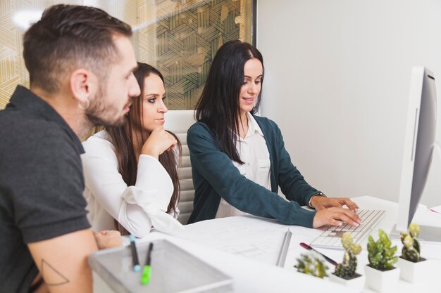 Pretty women and man working in office