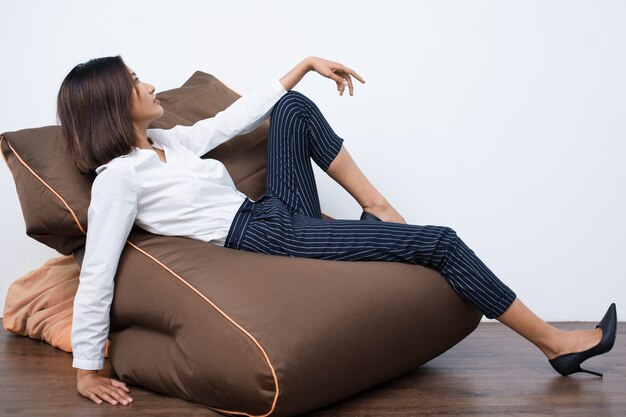 Pretty Young Asian Woman Resting on Beanbag Chair