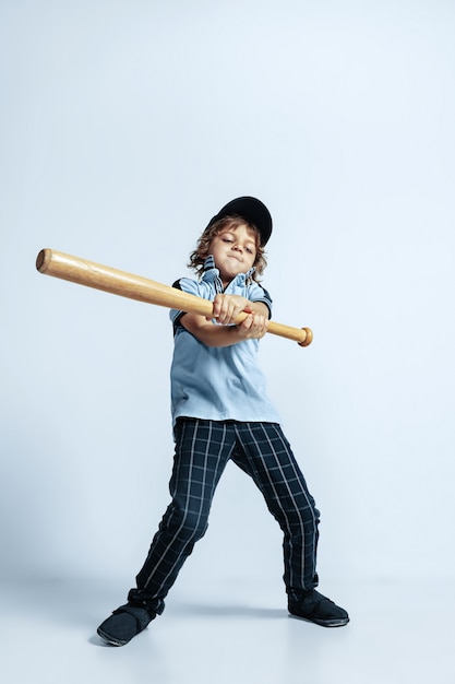 Pretty young curly boy in casual clothes on white studio