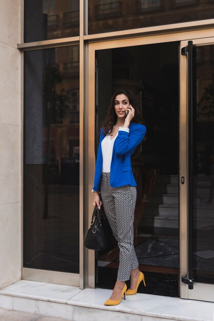 Pretty young executive talking on the phone