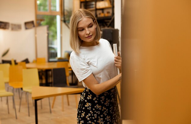 Pretty young girl posing at the library