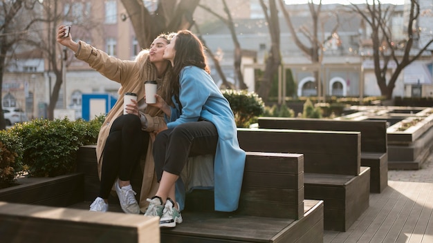 Free photo pretty young girl taking selfie together