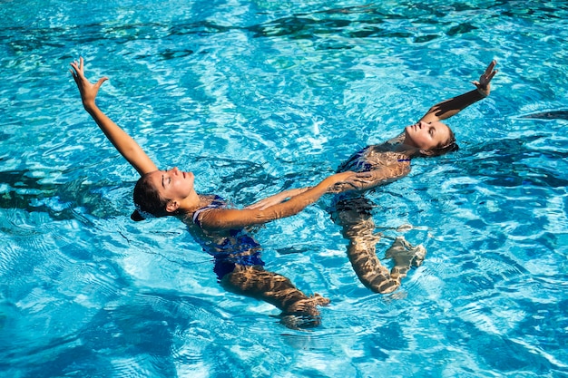 Pretty young girls enjoying time at the swimming pool