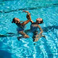 Free photo pretty young girls posing in the water