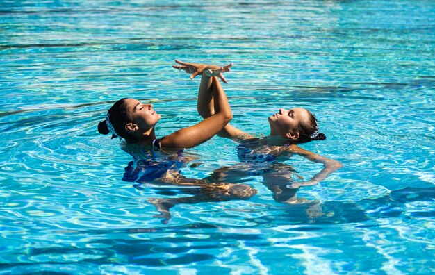 Pretty young girls posing in the water