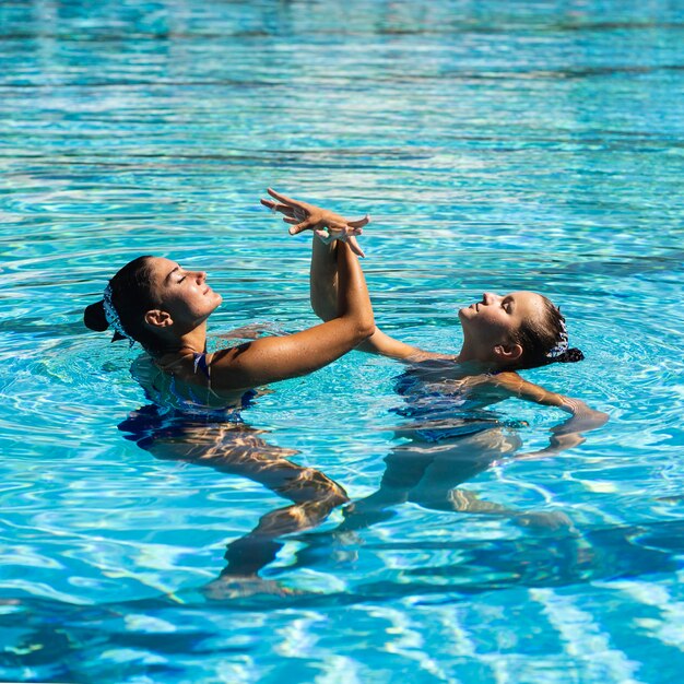 Pretty young girls posing in the water