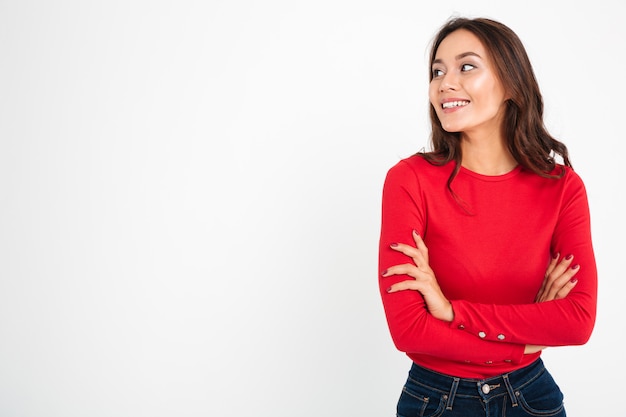 Pretty young happy woman standing with arms crossed