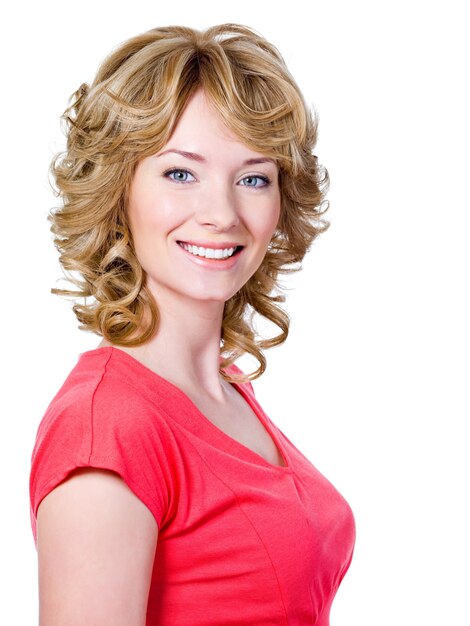 Pretty young happy woman with cheerful toothy smile - isolated on white