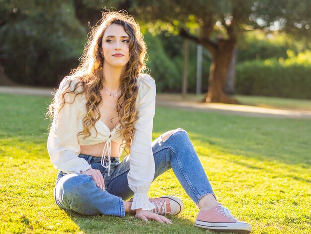 Pretty young lady in casual clothes spending leisure time in the spring park