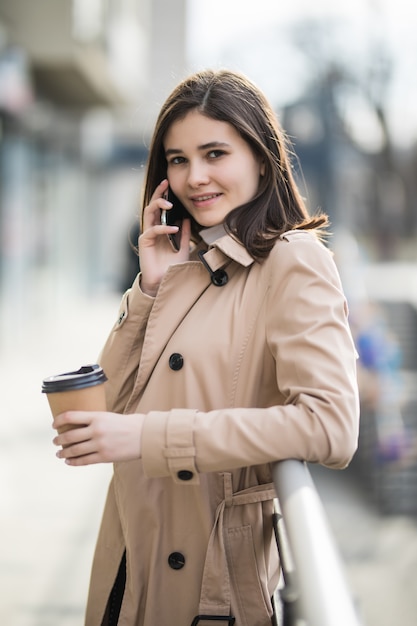 Pretty young lady with short hair talking on phone with somebody