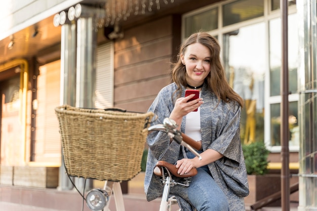 Free photo pretty young woman browsing mobile phone