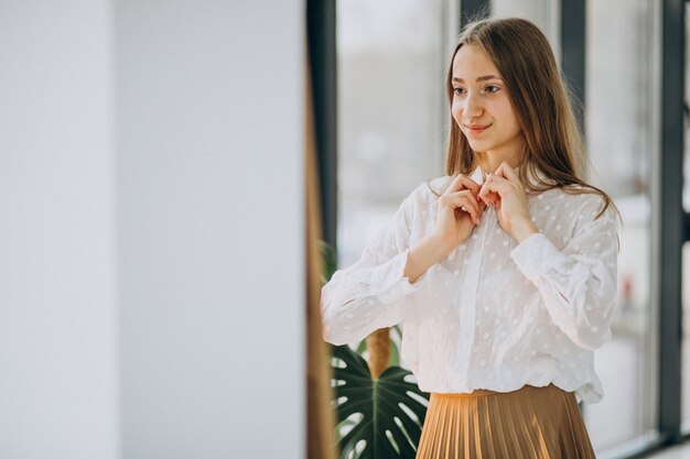 鏡を見てカジュアルな服装でかなり若い女性