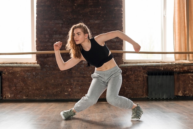 Pretty young woman dancing in the dance studio