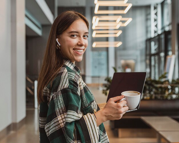 Pretty young woman enjoying a coffee break