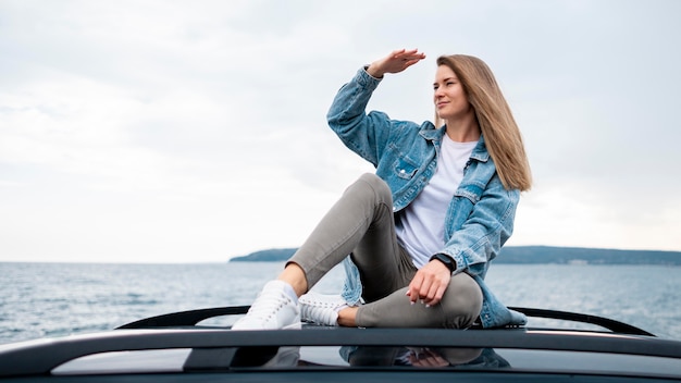 Pretty young woman enjoying road trip