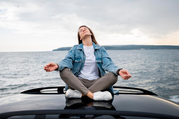 Pretty young woman enjoying road trip