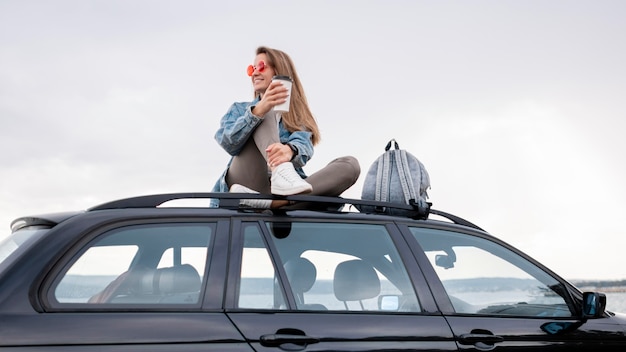 Pretty young woman enjoying road trip