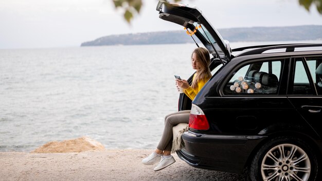 Pretty young woman enjoying road trip