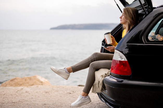 Pretty young woman enjoying road trip