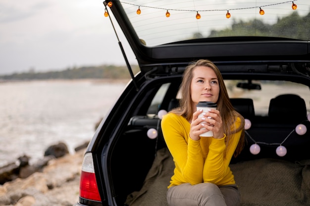 Pretty young woman enjoying road trip