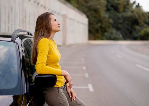 pretty young woman enjoying road trip
