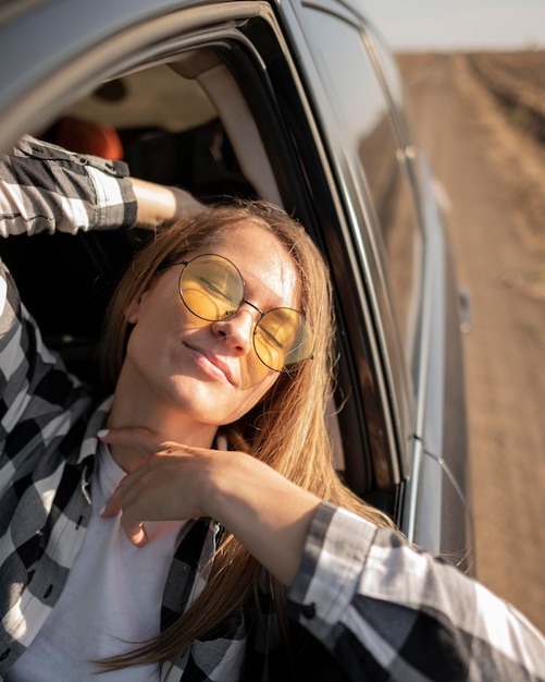pretty young woman enjoying road trip