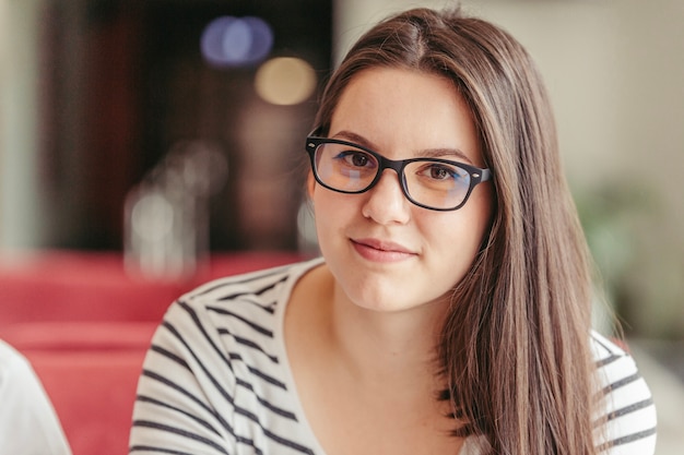 Pretty young woman in glasses