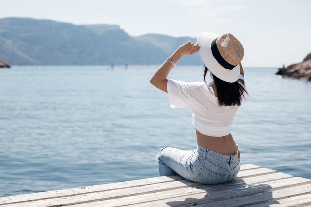 pretty young woman in hat backside