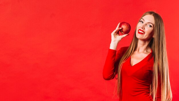 Pretty young woman holding an apple