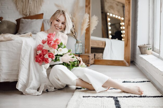 pretty young woman at home with flpwers