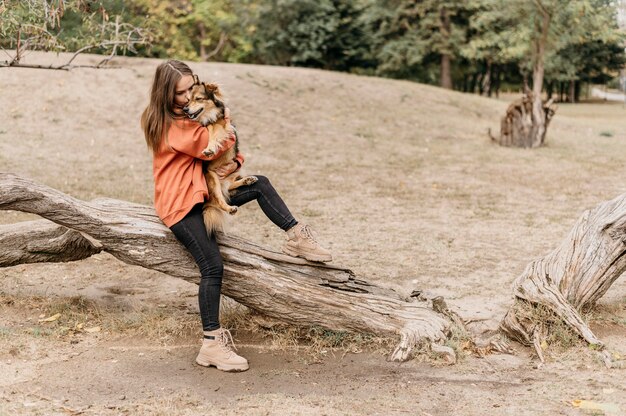 Pretty young woman petting her dog