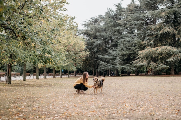 Pretty young woman petting her dog Free Photo