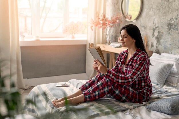 Pretty young woman reading a book