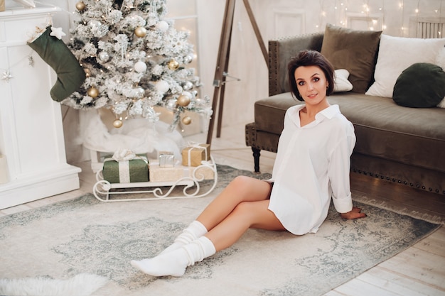 Pretty young woman resting in her loving room