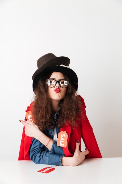 Pretty young woman with sale text on glasses lenses