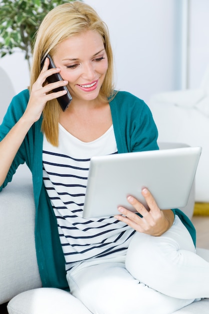 Pretty young woman working and using her mobile phone.