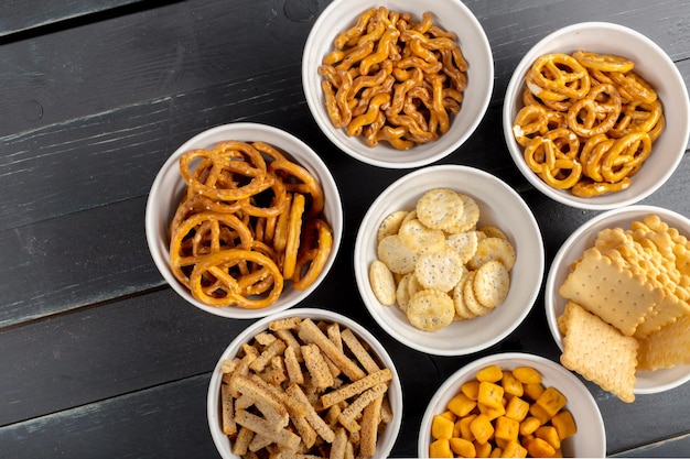 Free photo pretzels in bowls on wooden table from above