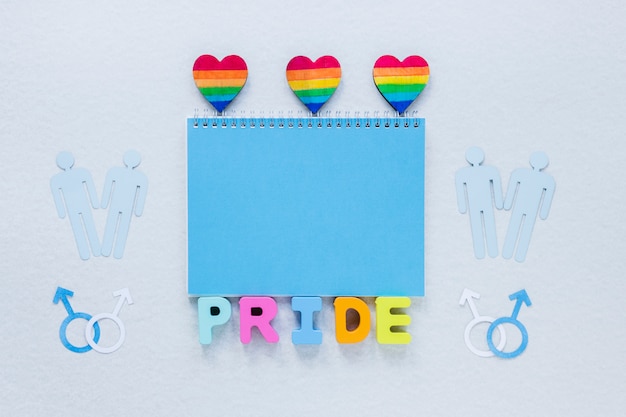 Pride inscription with rainbow hearts and gay couples icons